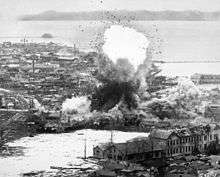A bomb explodes in a large coastal town