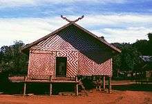 A stilted building with woven walls