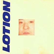 An extreme close-up of a Caucasian male surrounded by an off-white border with the word "LOTION" written vertically in blue along the left-hand side.