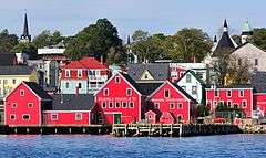 Churches and brightly colored houses near the water.