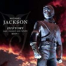 A image of a silver statue wearing a military-like outfit with its hair clipped behind its head. To the left of the statue the words "MICHAEL JACKSON" are written in white letters and underneath them is "HISTORY PAST PRESENT AND FUTURE BOOK I" written in smaller white print. Behind the statue, a sky with black and red clouds can be seen.