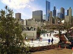 An ice skating ribbon with a city skyline in the background