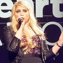 Meghan Trainor is looking away from the camera.