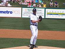 A Detroit Tigers pitcher getting ready to deliver a pitch during a baseball spring training game.