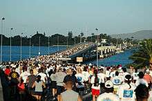 Hundreds of runners at the start line of a marathon at the O'ahu side of the Admiral Clarey bridge.