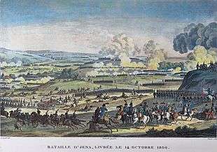 Print of a battle with Napoleon and his staff in the foreground and long lines of soldiers moving away from the viewer. In the center of the picture there is a hill that is being fought over.