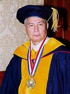Angel Alcala, national scientist, is seen wearing deep blue and yellow academic gown with cap, deep blue with gold tassel.