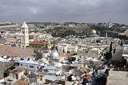 City view with houses, churches and a building with a large golden dome.