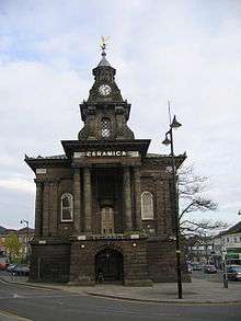 Burslem Town Hall, a stone building adorned with a golden angel on its tower. The Hall was the scene for many debates and ballots during the Federation process
