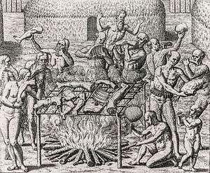 Woodcut showing 12 people holding various human body parts carousing around an open bonfire where human body parts, suspended on a sling, are cooking.