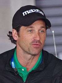 Patrick Dempsey wearing a cap looking away from the camera