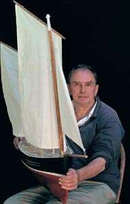 knee high portrait of subject carrying a three-foot sailboat
