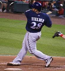 Prince Fielder, wearing the alternate navy-blue Brewers home jersey, in his follow-through after a pitch