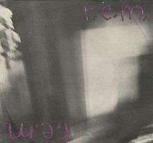 A blurry black-and-white photo with "r.e.m." scrawled in purple in the top right corner and again upside down in the bottom left corner