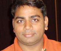 Head and face photo of Rajeev Kumar Varshney, big eyes, straight hair, smiling slightly
