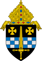 An image of a coat of arms: a golden sword laid over a fess chequy blue and silver and two gold rounded crosses pattée in chief, with a bishop's mitre surmounting the shield.