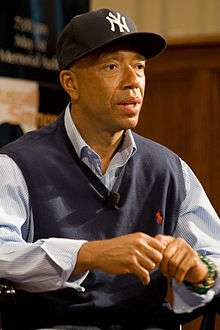 Russell Simmons, in a sweater vest and New York Yankees baseball cap