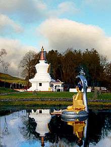 a ginormous muckle stupa in bonny Scotland with a wee Buddha in front
