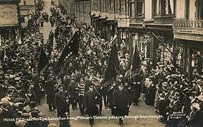 A Salvation Army funeral cortege marching through the street of Senghenydd