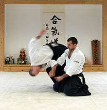 A version of the "four-direction throw" (shihōnage) with standing attacker and seated defender.