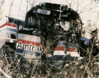 Derailed diesel locomotive with significant damage in the front