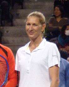 A blonde haired woman in a white polo shirt