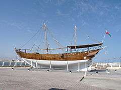 A picture of an Arabian dhow, a ship constructed with a covered area at the rear and no real superstructure. They are used as cargo vessels and have one or two masts with triangular sails.
