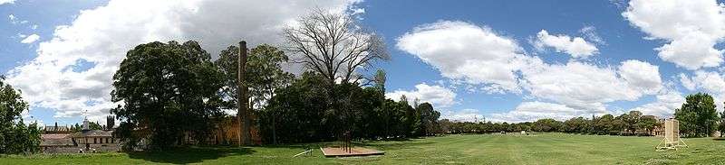 St Paul's Oval—a large, green, tree-lined field under a blue sky with clouds