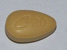 A tan teardrop-shaped tablet with C20 engraved on it