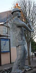 Statue of miner with raised pick