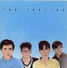 Pastel pictures of The Feelies' faces on a blue background with "THE FEELIES" written in black above them