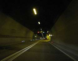 Inside of Mala Kapela Tunnel when operated as a single tube tunnel featuring a double solid line dividing the traffic lanes and variable traffic signs indicating two way traffic in the tunnel.