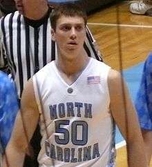 A basketball player wearing a white jersey with the number 50 on it.