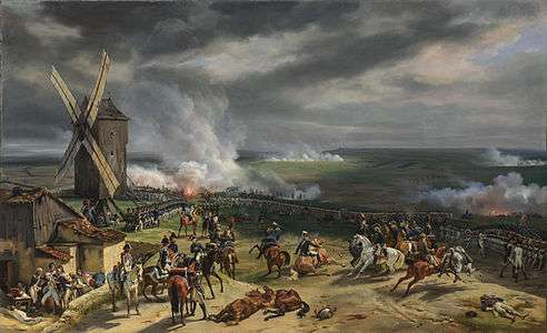 Painting shows a view from a hilltop with windmill at the left and long lines of infantry.