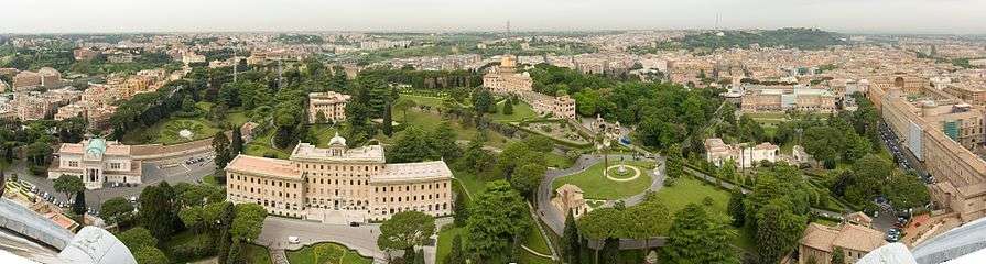 A panorama of gardens and several buildings from atop St. Peter's Basilica