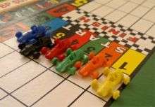 Six racing car shaped playing pieces from Waddington's Formula 1.