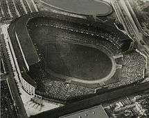 Black and white aerial view of Old Yankee Stadium, looking towards home plate from the outfield.