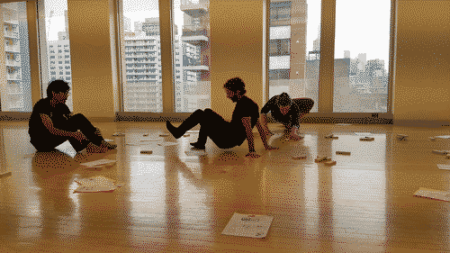 three people sitting in different ways in the floor